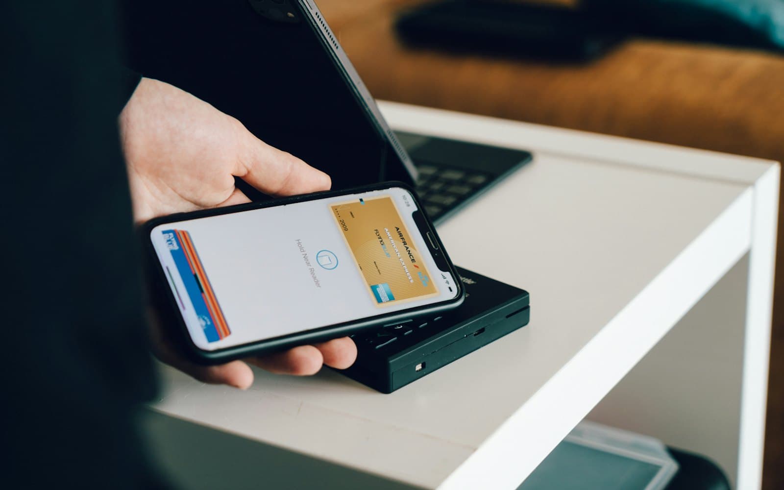 A phone held against a card reader